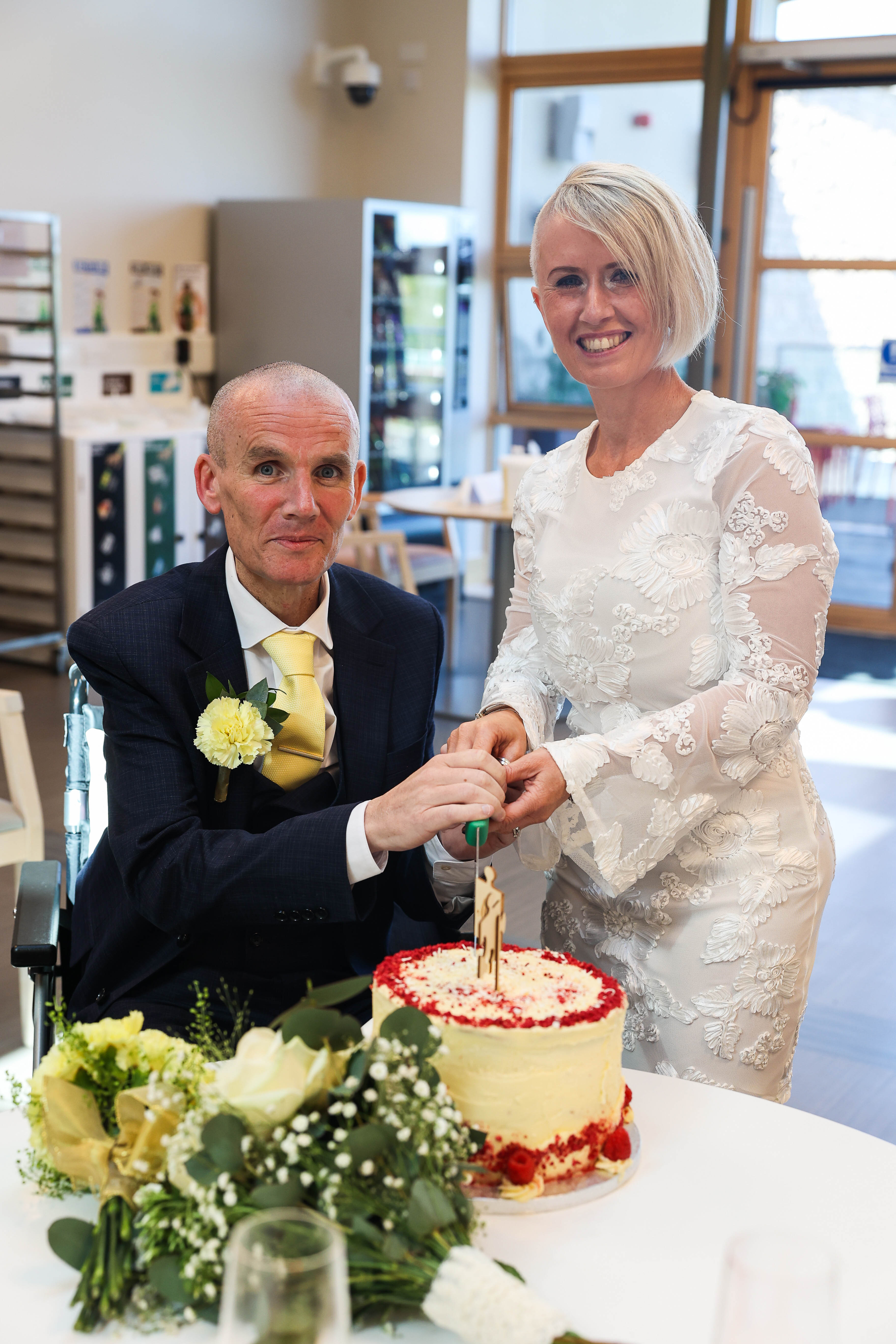 Antoinette and Damien cut the wedding cake together