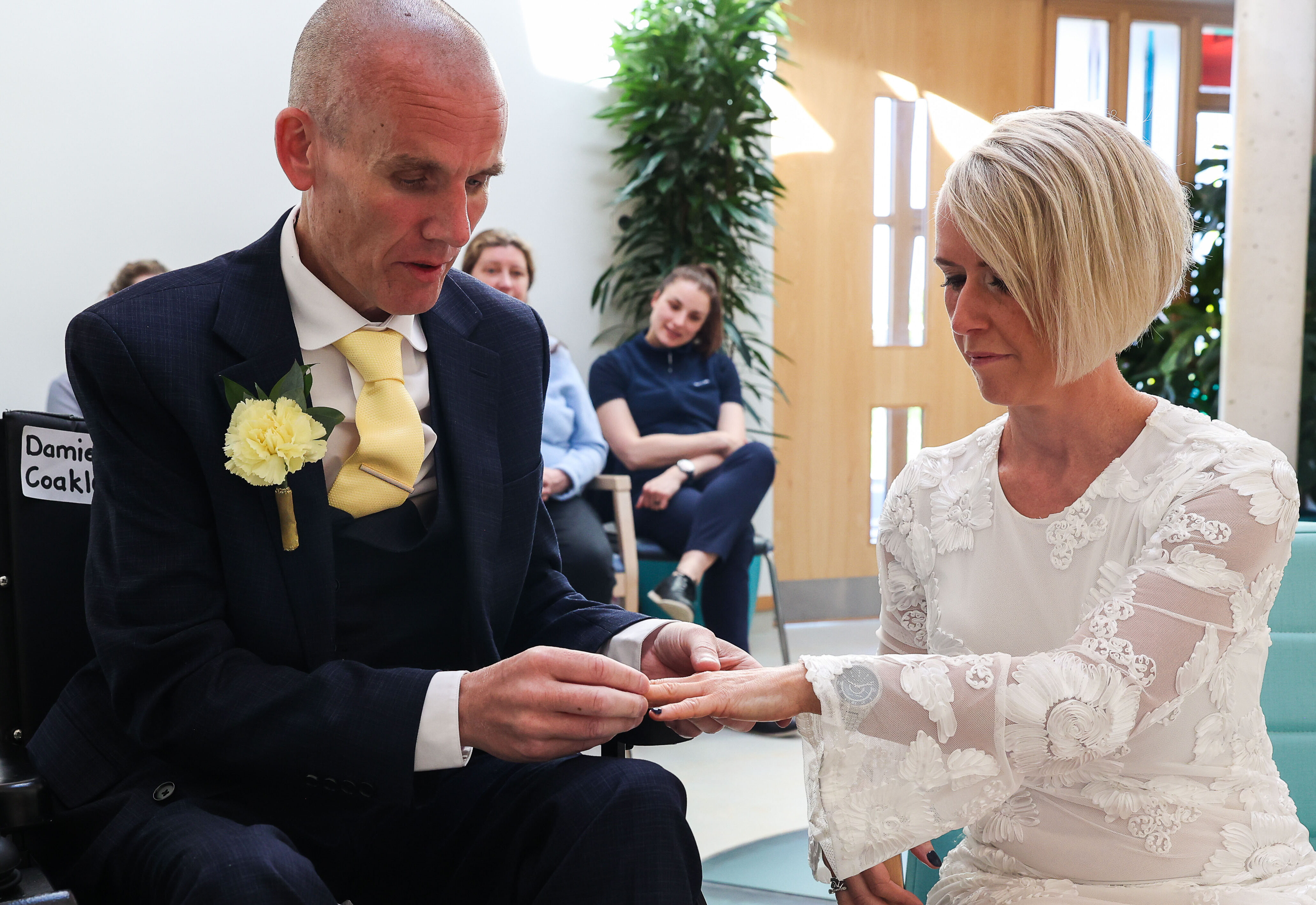 Antoinette and Damien exchange rings during the wedding ceremony at Wicklow Hospice