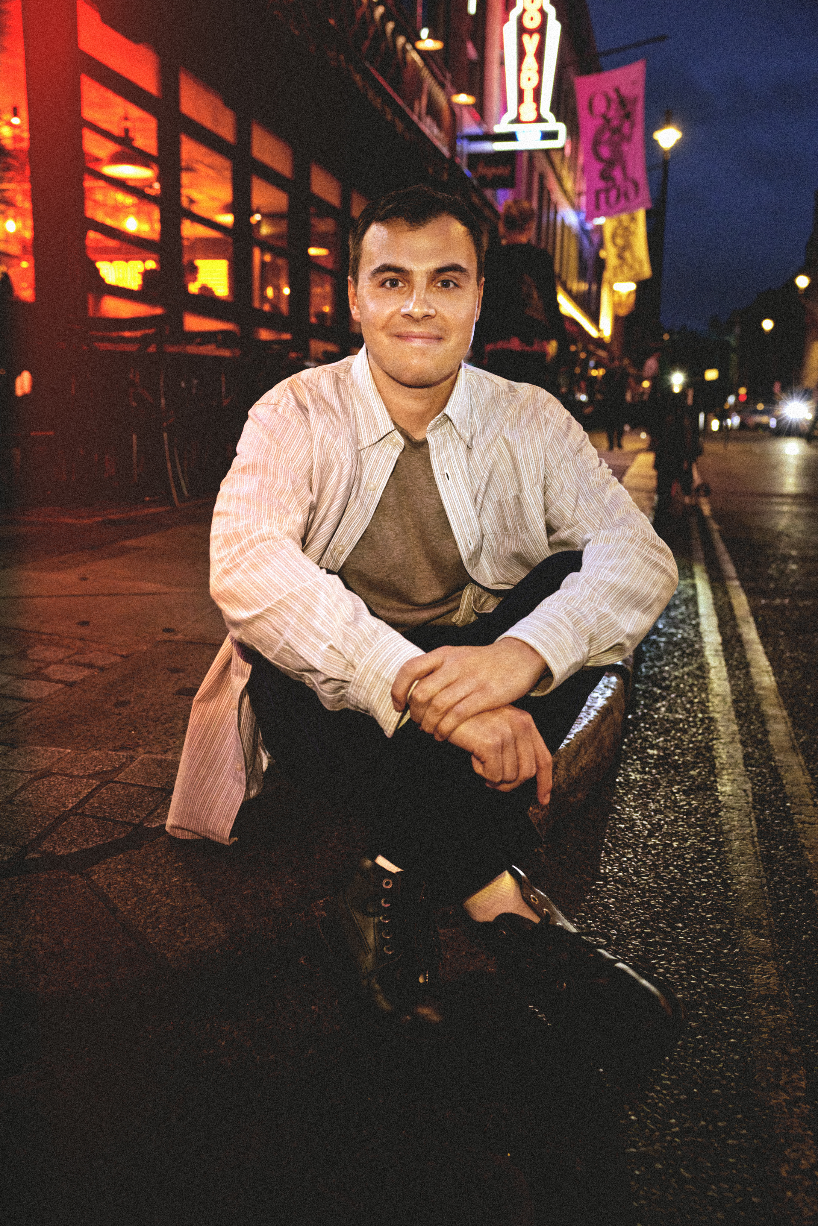 Freddie Meredith sitting down with his arms and legs crossed