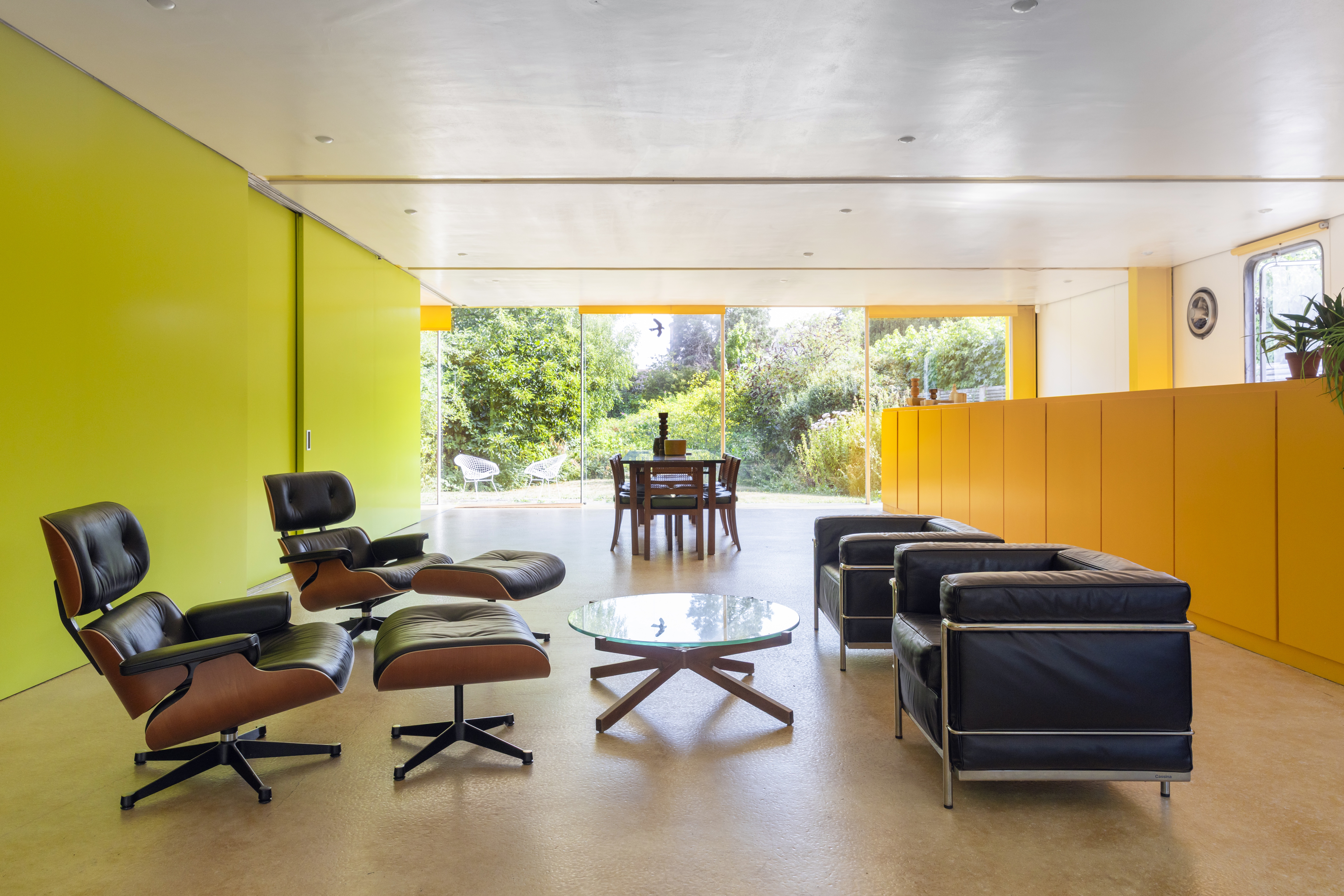 View of a living space, with tables and chairs, with bright green walls