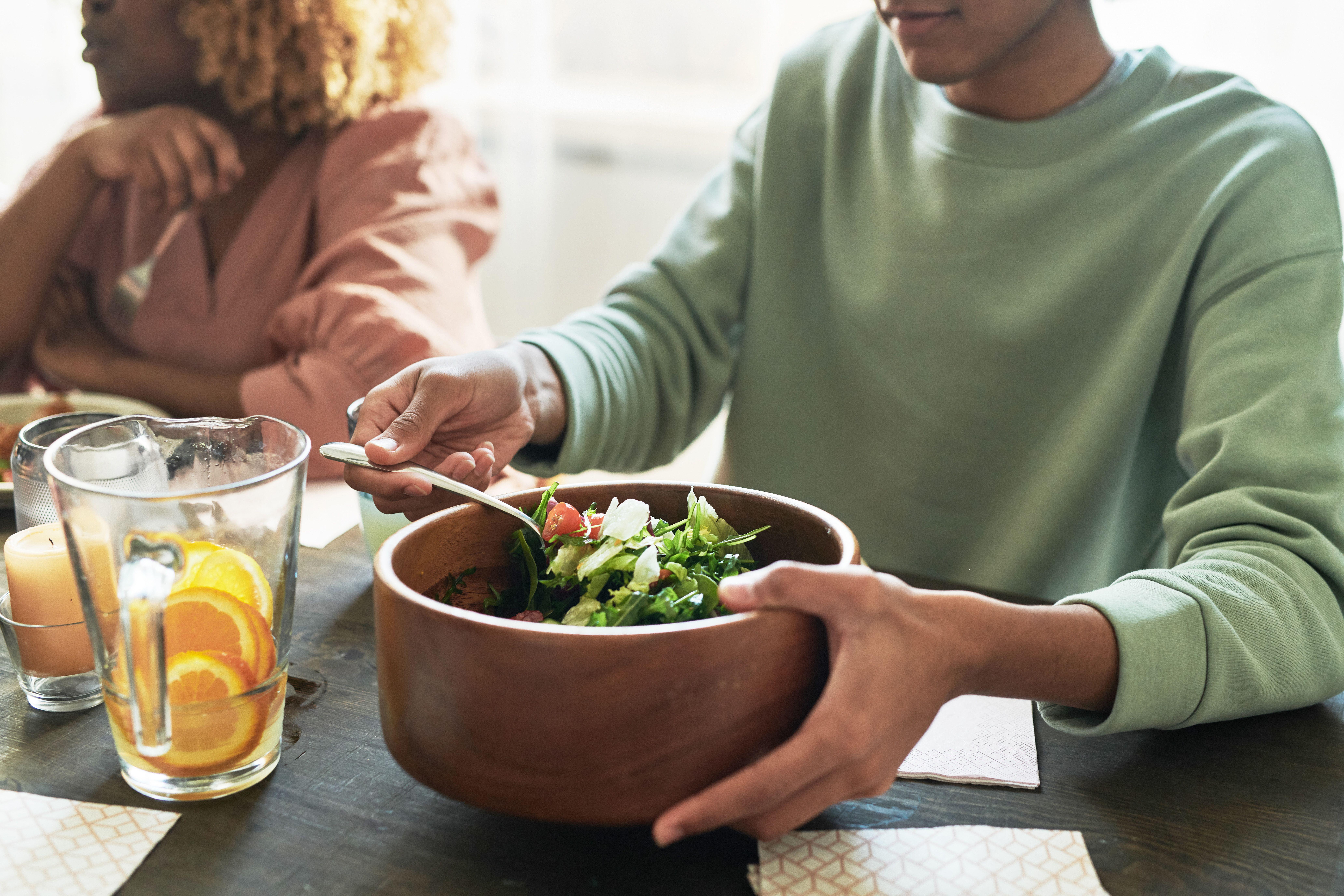A person holding a salad