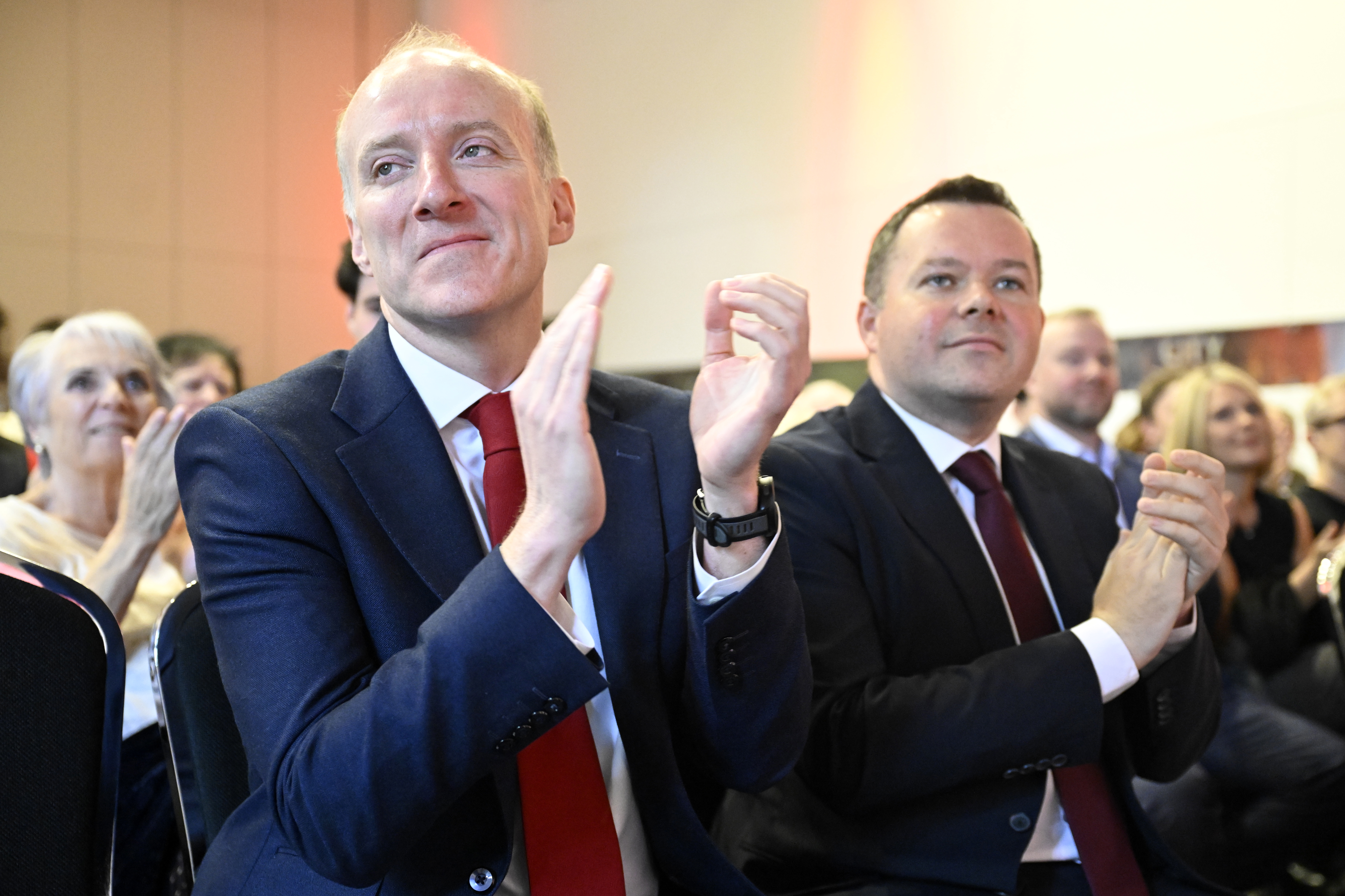 Michael Marra (left) and fellow MSP Joe Fagan clapping