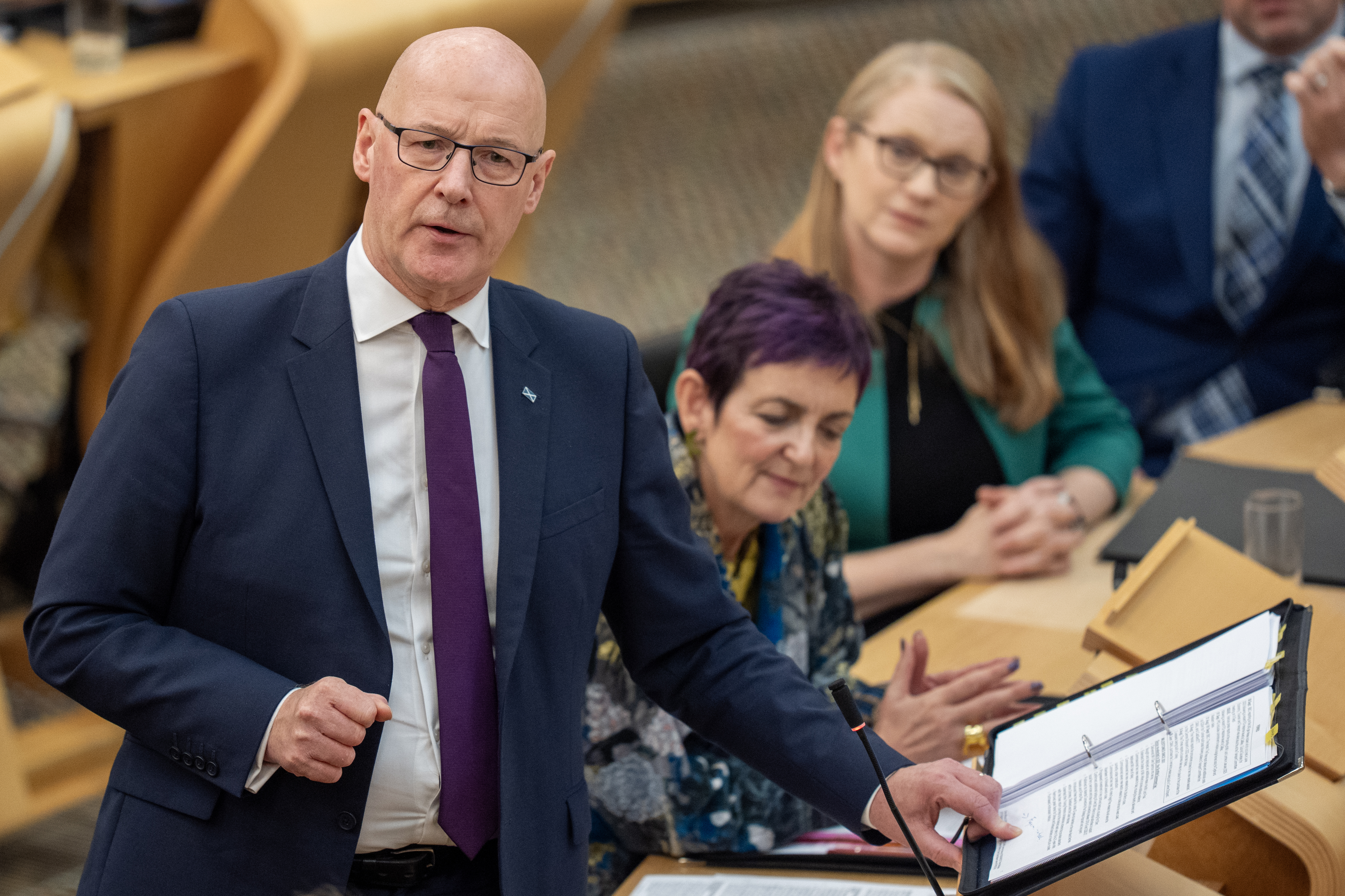 John Swinney standing while speaking in Holyrood