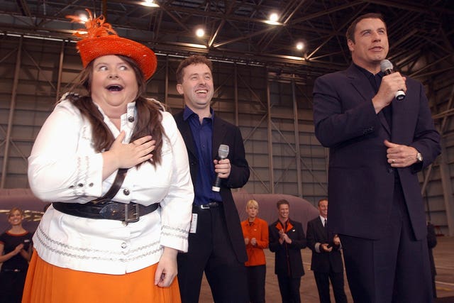 Magda Szubanski, left, with John Travolta, right, in 2004