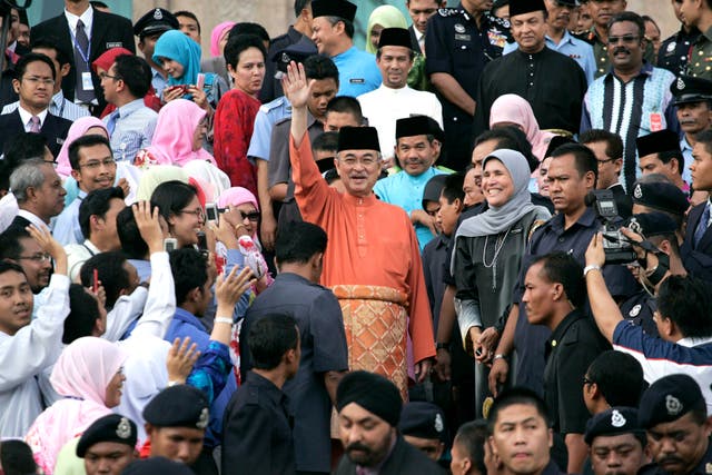 Abdullah waves to a crowd