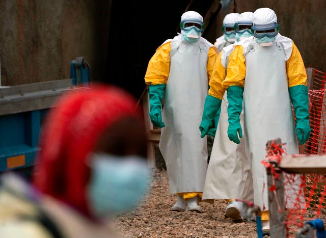 Health workers dressed in protective gear begin their shift at an Ebola treatment centre in Beni