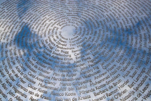 The sky is reflected in the national MH17 monument which carries the names of the victims