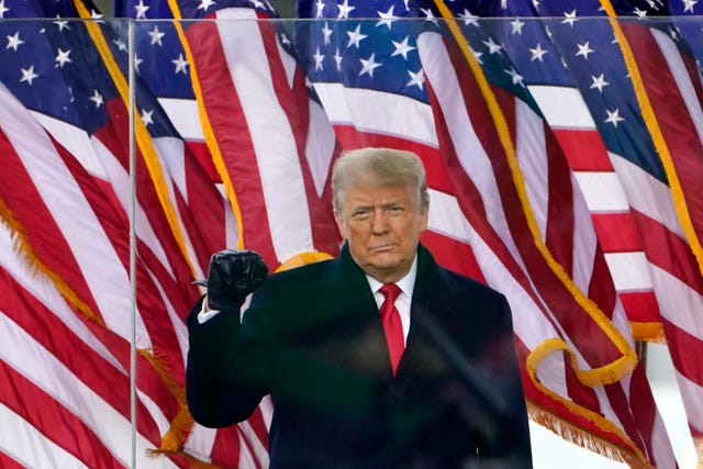 Former president Donald Trump gestures as he arrives to speak at a rally in Washington