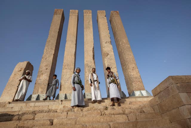 Armed men allied to Yemen’s internationally recognised government pose for a photograph at Awwam Temple, also known as the Mahram Bilqis, in Marib, Yemen