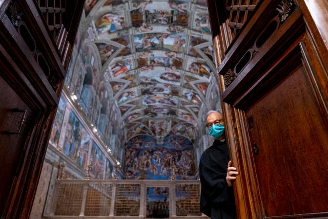 Custodian of the Apostolic Shrine Padre Bruno Silvestrini closes the doors to the Sistine Chapel at the Vatican in Rome