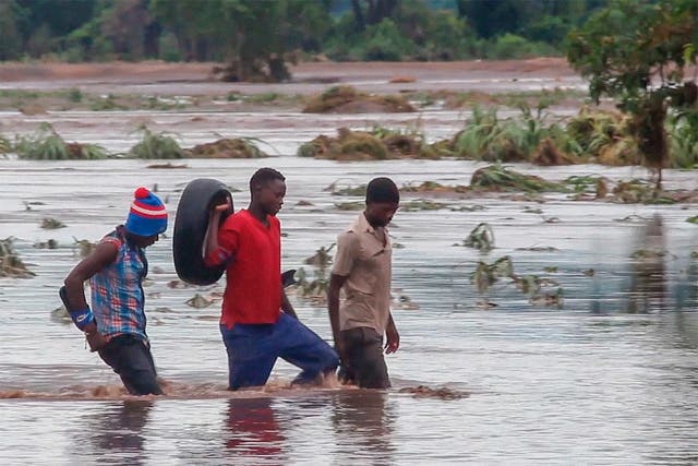 People walk through floods