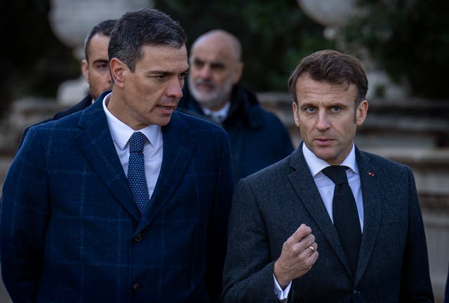 French President Emmanuel Macron, right, talks with Spanish counterpart Pedro Sanchez in Barcelona