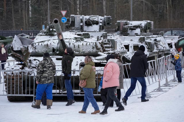 People visit an exhibition of tanks and armoured personnel carriers of Ukrainian armed forces damaged and captured during the fighting at an exhibition in Kirovsk in Russia
