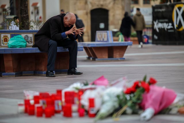 A man reacts next to a memorial site for a church sacristan who was killed in Algeciras, southern Spain