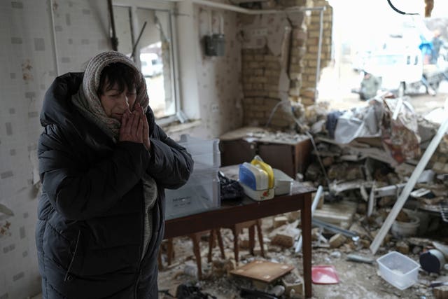 Halina Panasian, 69, reacts inside her destroyed house after a Russian rocket attack in Hlevakha, Kyiv region, Ukraine