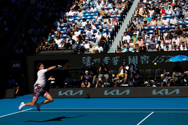 Stefanos Tsitsipas leaps into a forehand