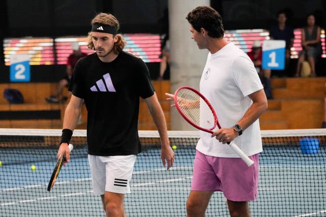 Stefanos Tsitsipas, left, speaks to coach Mak Philippoussis in practice ahead of the final