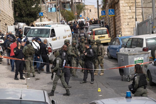 An Israeli policeman secures a shooting attack site in east Jerusalem