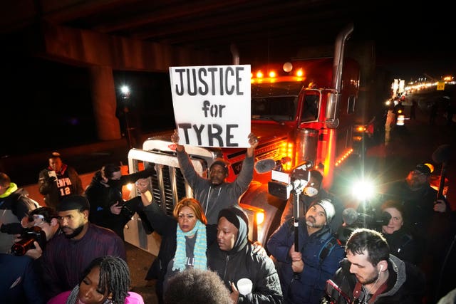 Protesters march down the street on Friday in Memphis as authorities release police video depicting five Memphis officers beating Tyre Nichols, whose death resulted in murder charges and provoked outrage at the country’s latest instance of police brutality