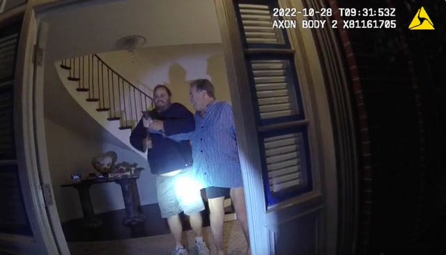 Paul Pelosi, right, fights for control of a hammer with David DePape