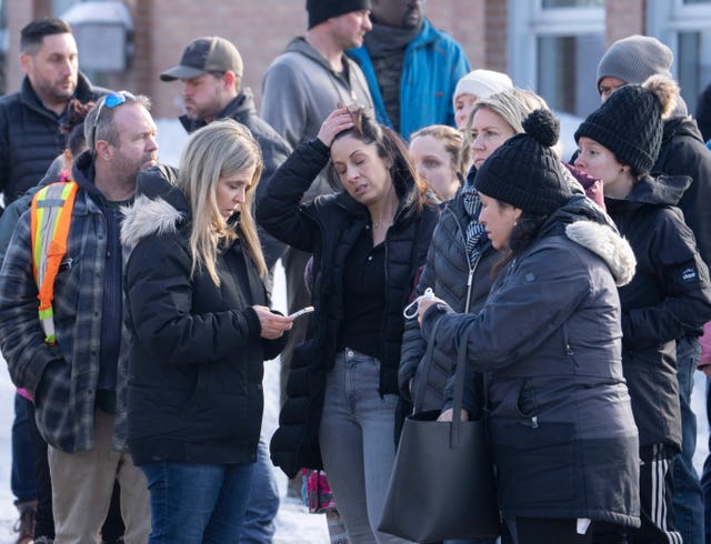 Families wait for news after a bus crashed into a daycare centre in Laval, Quebec