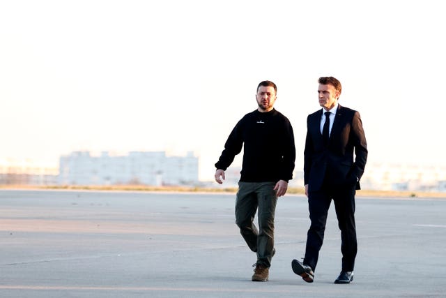 French President Emmanuel Macron, right, walks next to Ukraine’s President Volodymyr Zelensky before heading to Brussels