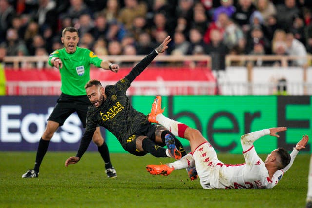 PSG’s Neymar, centre, and Monaco’s Ruben Aguilar fight for the ball