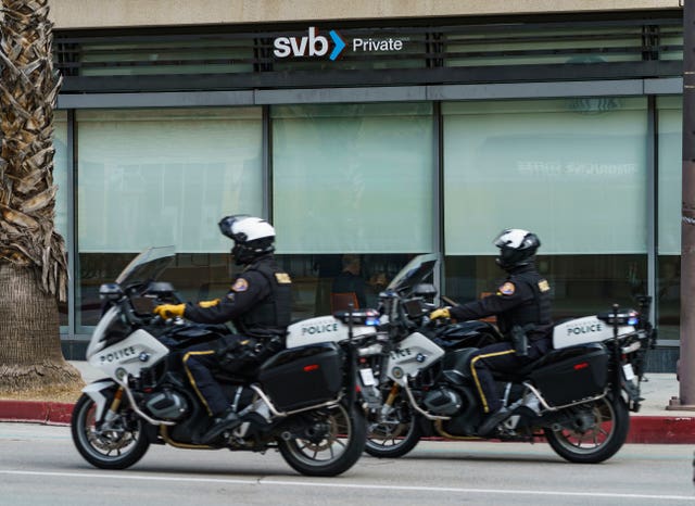Pasadena police officers drive past the open Silicon Valley Bank Private branch in Pasadena, California
