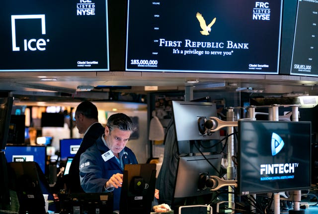 Traders work on the floor at the New York Stock Exchange in New York