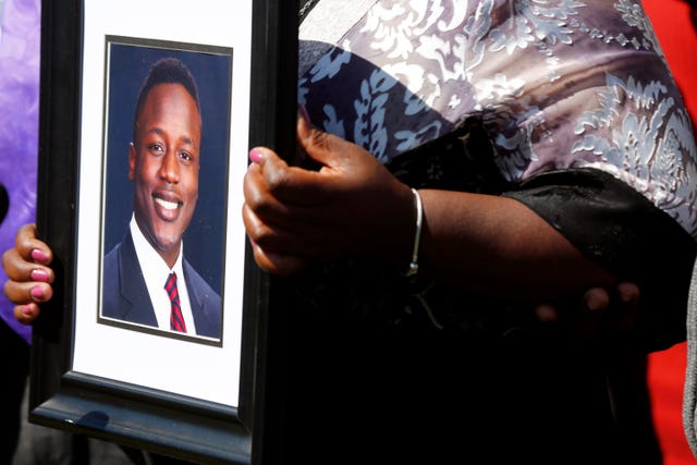 Irvo Otieno's mother Caroline Ouko holds a portrait of her son at the Dinwiddie Courthouse in Virginia