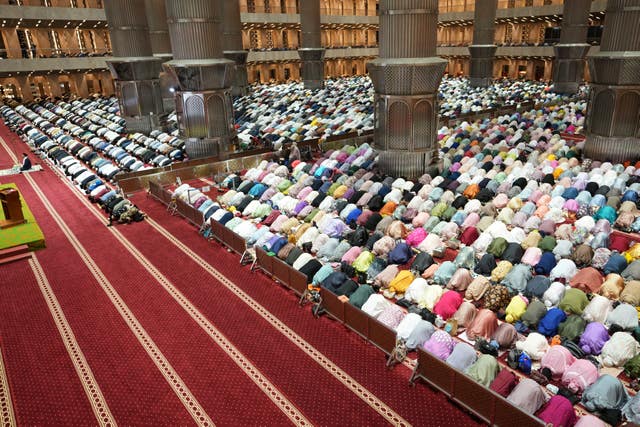 Indonesian Muslims perform a prayer marking the first eve of the holy fasting month of Ramadan at Istiqlal Mosque in Jakarta, Indonesia