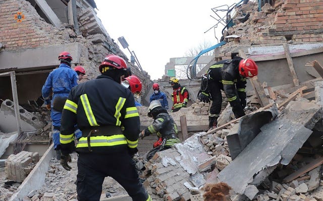 Emergency personnel work at the scene of a drone attack in the town of Rzhyshchiv