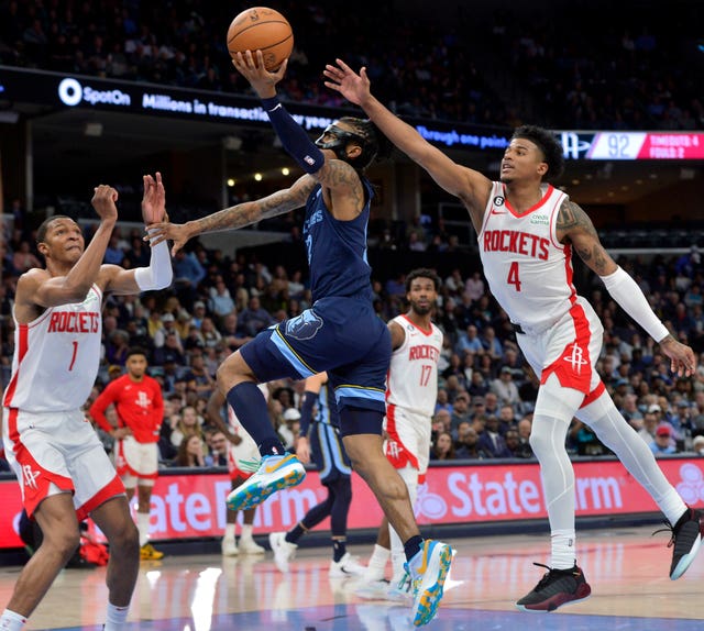 Houston Rockets players surround Memphis Grizzlies guard Ja Morant