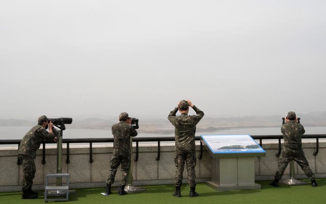 South Korean army soldiers watch the North Korea side from the Unification Observation Post in Paju, South Korea, near the border with North Korea