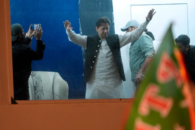 Former prime minister Imran Khan waves to supporters during the rally