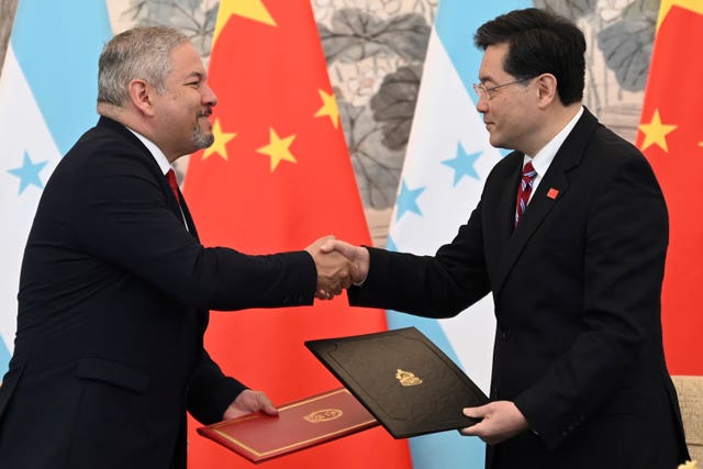 Honduras foreign minister Eduardo Enrique Reina Garcia, left, and Chinese foreign minister Qin Gang shake hands following the establishment of diplomatic relations between the two countries at a ceremony in Beijing