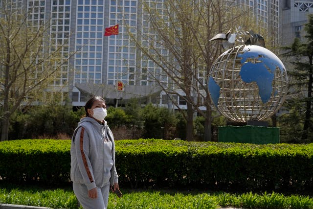 A woman walks past the ministry of foreign affairs in Beijing