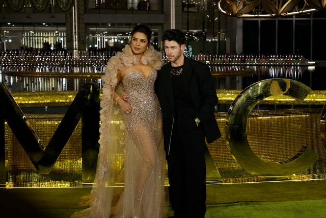Indian actress Priyanka Chopra and American singer, songwriter and actor Nick Jonas stand for photographs during the inaugural function of Nita Mukesh Ambani Cultural Centre in Mumbai