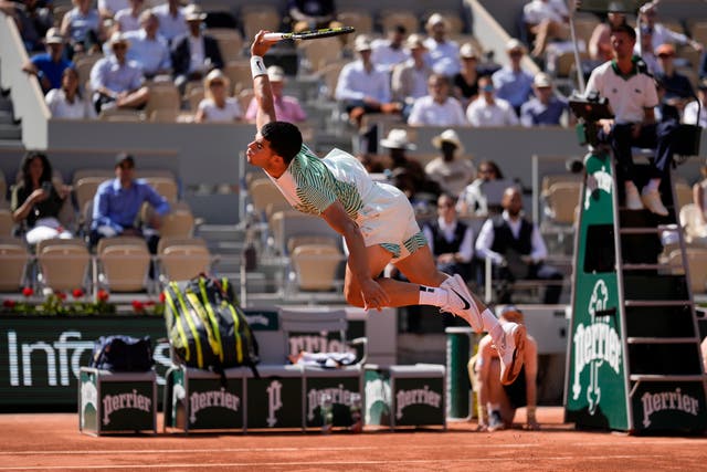 Carlos Alcaraz leaps for a shot against Taro Daniel