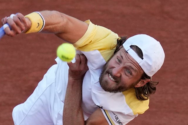 France’s Lucas Pouille hits a serve