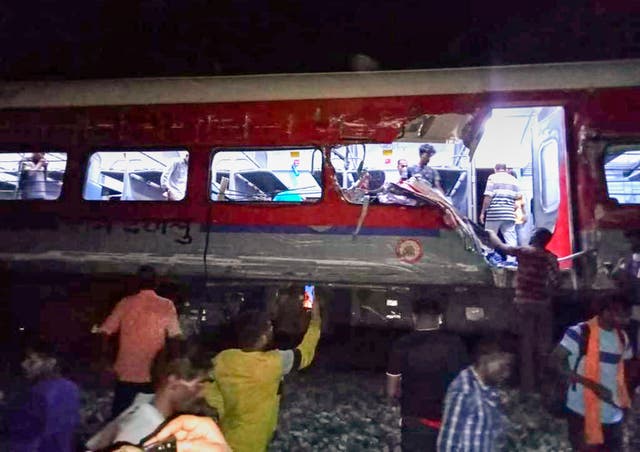 People inspect the site of passenger trains that derailed in Balasore district, in the eastern Indian state of Orissa, Friday, June 2, 2023