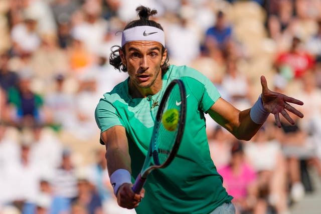 Lorenzo Musetti plays a backhand