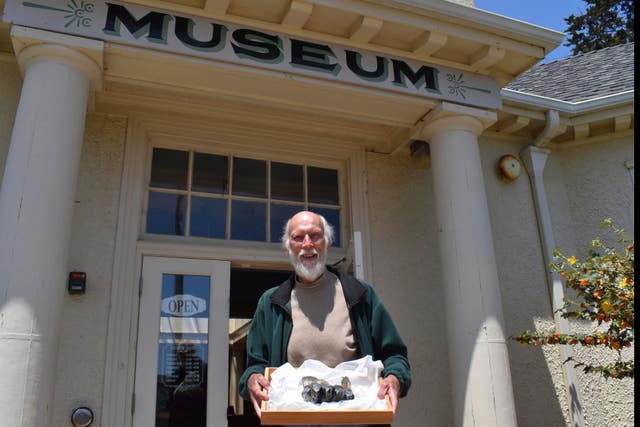 Jim Smith holding a Mastodon tooth