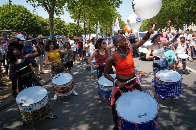 Demonstrators bang drums during a protest in Paris, France