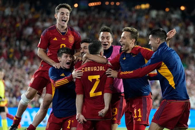 Spain's players celebrate after Dani Carvajal converted the winning penalty in a tense shoot-out
