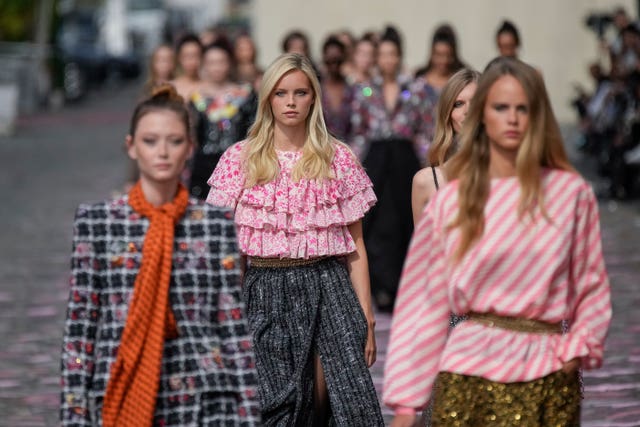 Models wear creations for the Chanel Haute Couture Fall/Winter 2023-2024 fashion collection