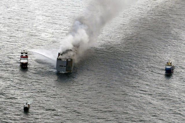A boat hoses down the ship
