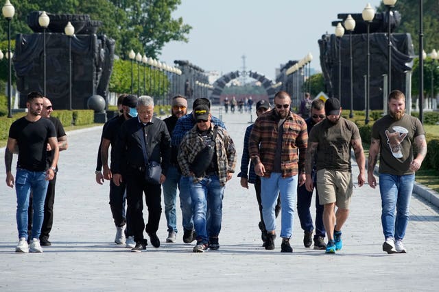 Colleagues of Dmitry Utkin, who oversaw the Wagner Group’s military operations, walk after a farewell ceremony for him at the Federal Military Memorial Cemetery in Mytishchy, outside Moscow, Russia