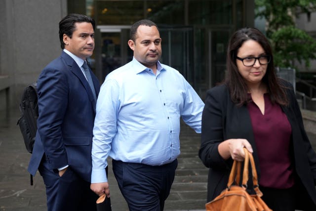 Wael Hana, centre, leaves court