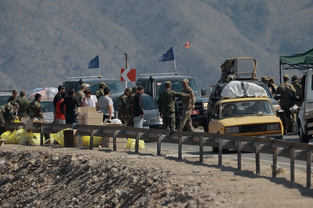 Ethnic Armenians from Nagorno-Karabakh and European Union observers drive past a check point on the road from Nagorno-Karabakh to Armenia’s Goris in Syunik region